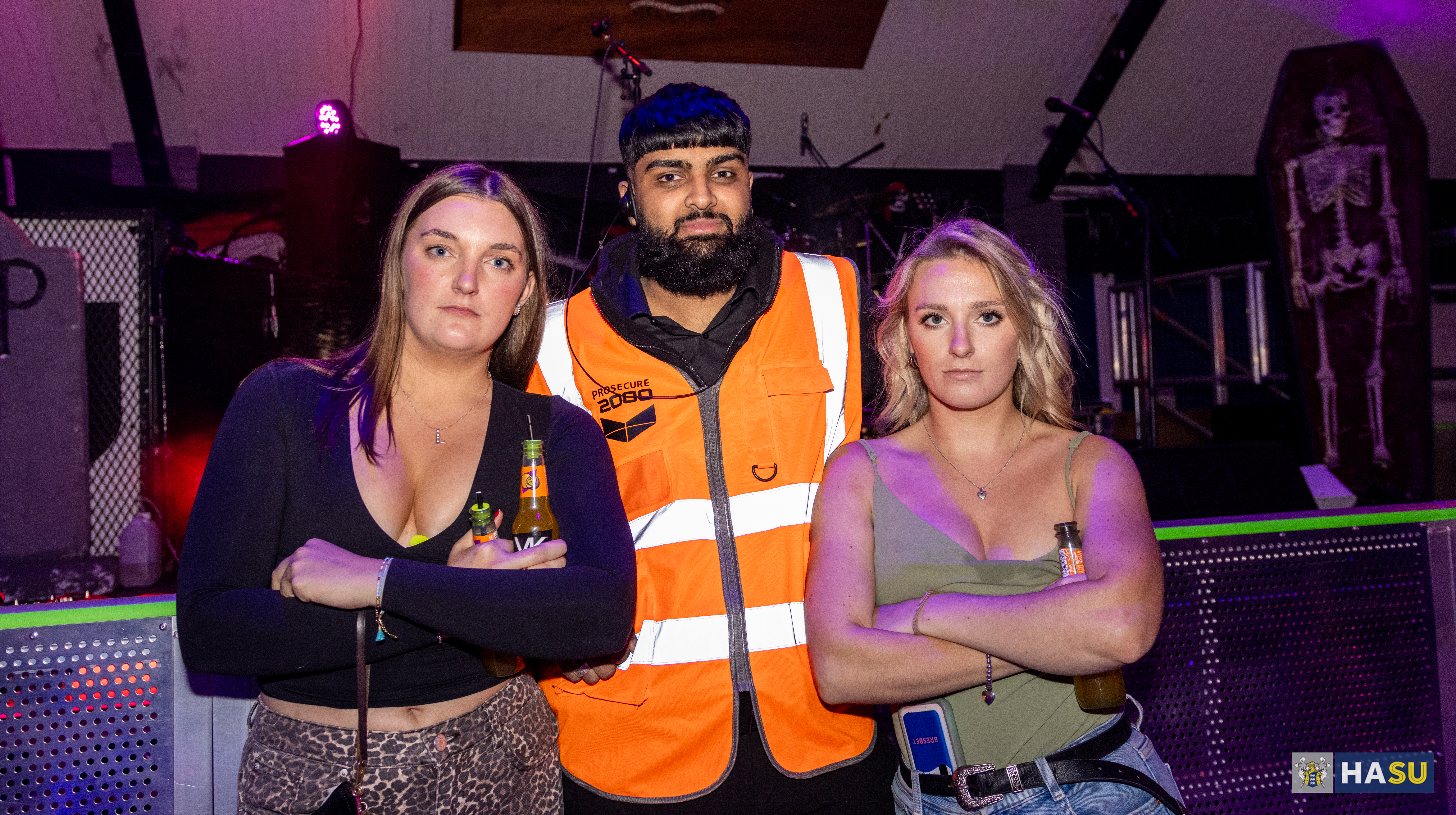 Security officer with two student posing seriously